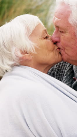 senior man kissing senior woman