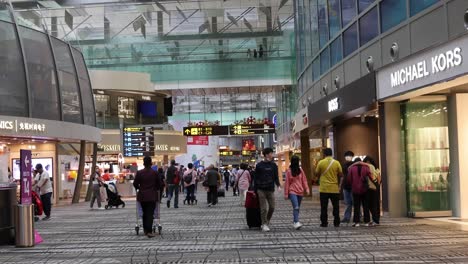 crowds navigating through a bustling airport terminal