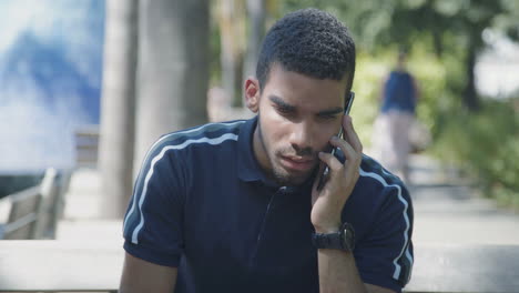 concentrated young man talking on phone, looking surprised