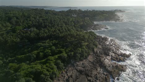 Descending-Establishing-Aerial-Drone-Shot-of-Rocky-Tropical-Coastline-on-Sunny-Day-in-Southern-Sri-Lanka