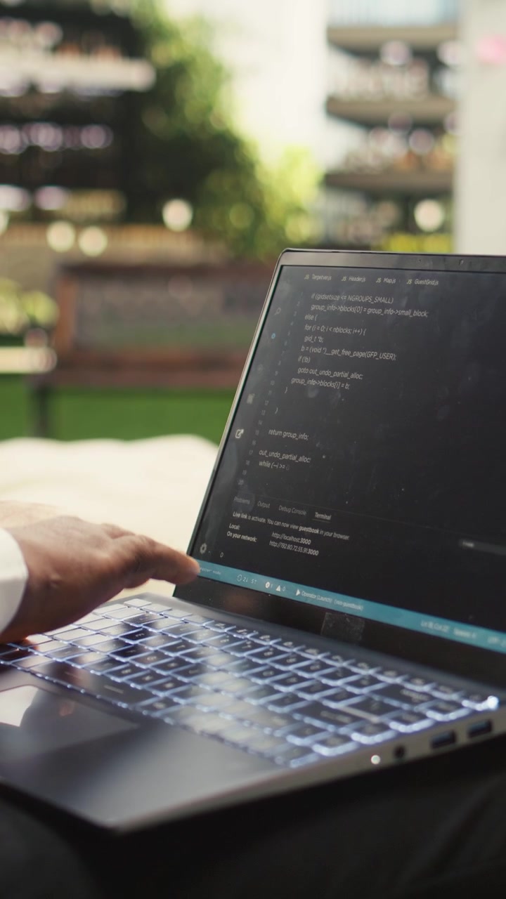 Vertical Video Businessman programmer using binary code on laptop during informal work