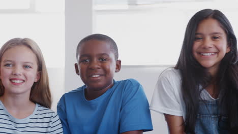 Portrait-Of-Smiling-Male-And-Female-Elementary-Students-In-School-Classroom