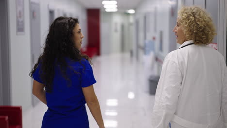 two doctors walking down a hospital corridor