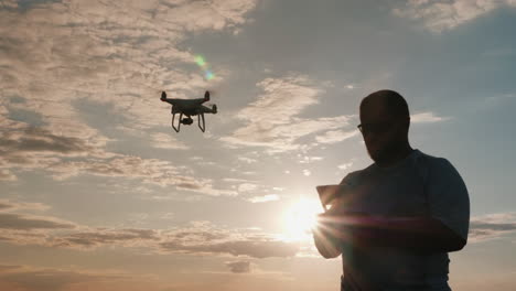 The-Man-Controls-The-Drone-While-The-Camera-Follows-It-1