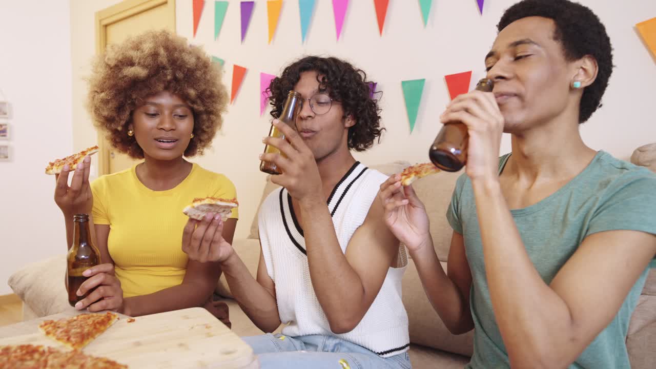 Friends having a pizza and beer party