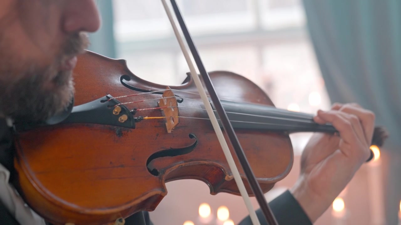 Close-up of a Musician Playing a Violin with a Bow