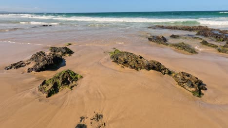 waves gently washing over rocks on beach