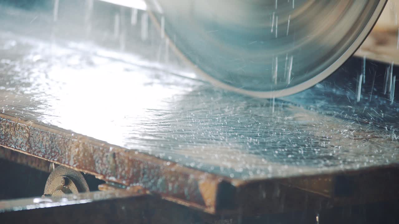 Drops of water falling on the table and on a circular saw for cutting a stone