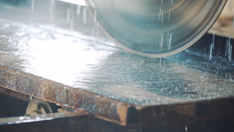 drops of water falling on the table and on a circular saw for cutting a stone