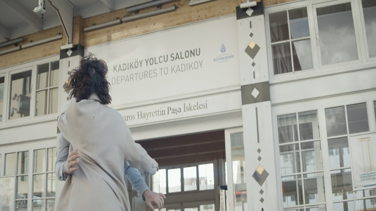 una pareja besándose en la terminal del ferry.