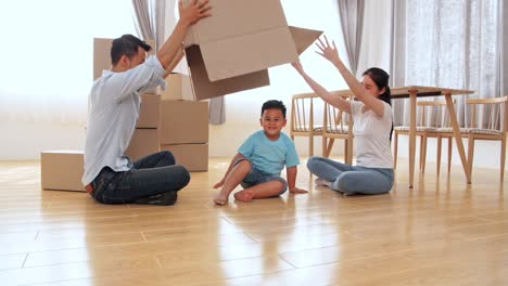 happy asian family having fun at new home