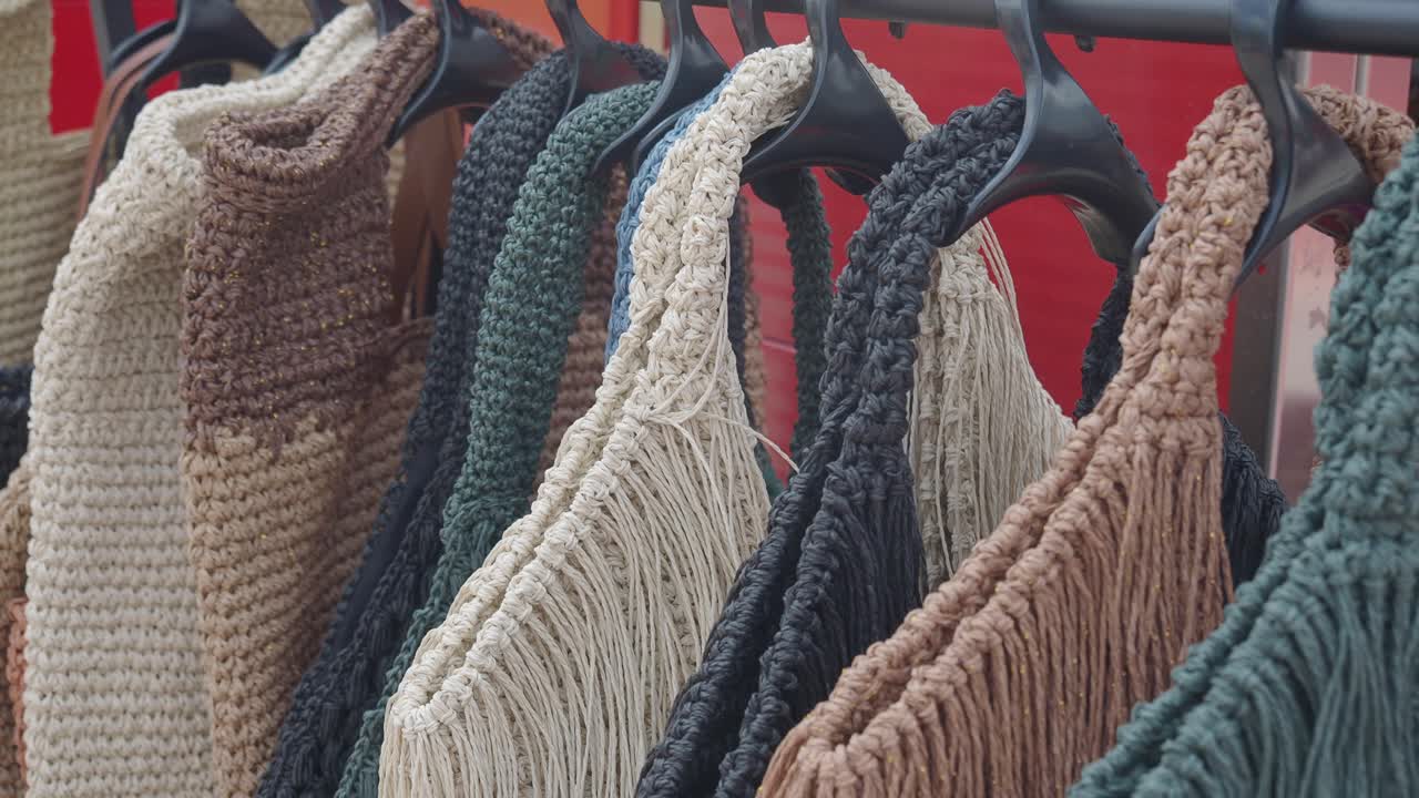 Variety of Crochet and Woven Bags on Hangers