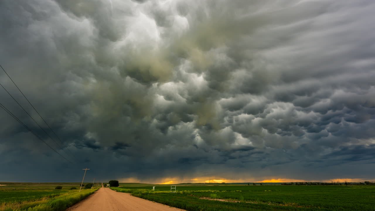 Beautiful cloud textures moving over quiet country road
