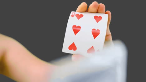 hand shuffling and pushing cards towards the camera