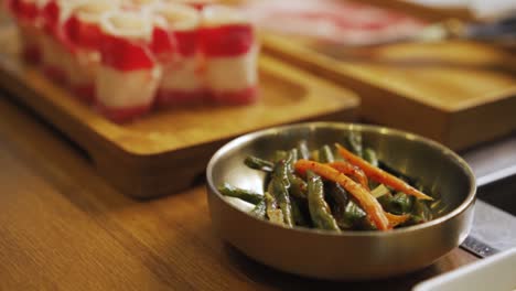 small bowl of stir-fried long beans as a side dish in korean restaurant