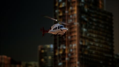 slow motion helicopter near skyscrapers at night