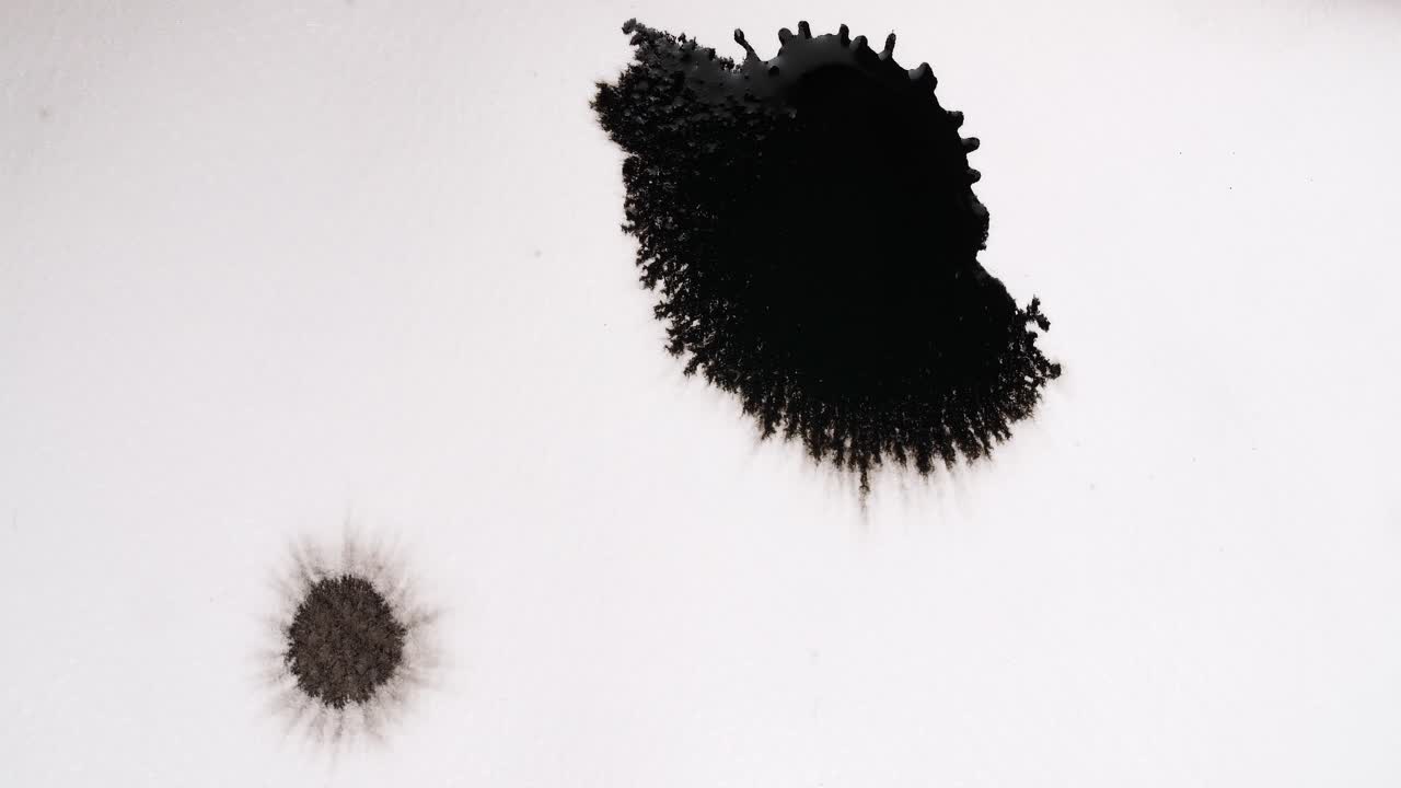 Black Ink Drops On White Background