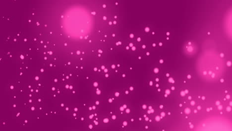 manchas brillantes que se mueven contra un fondo rosado