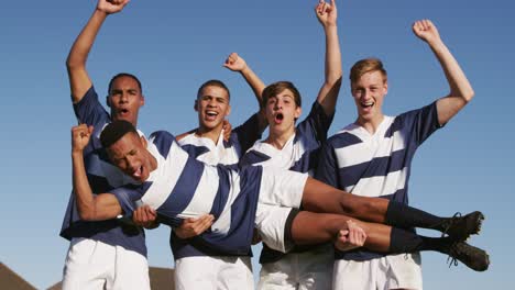 rugby players celebrating on the field