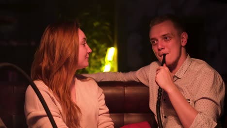 couple relaxing with hookah