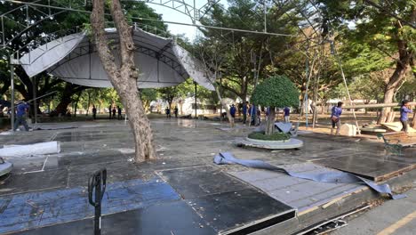 workers assembling a stage in a park setting