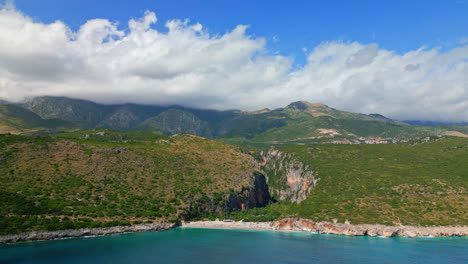 Aerial-drone-panning-shot-over-secluded-Gjipe-beach-in-Albania-on-a-sunny-day