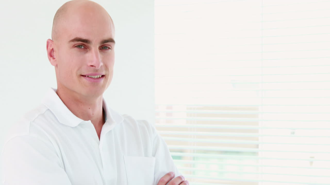 Smiling therapist standing with massage chair 