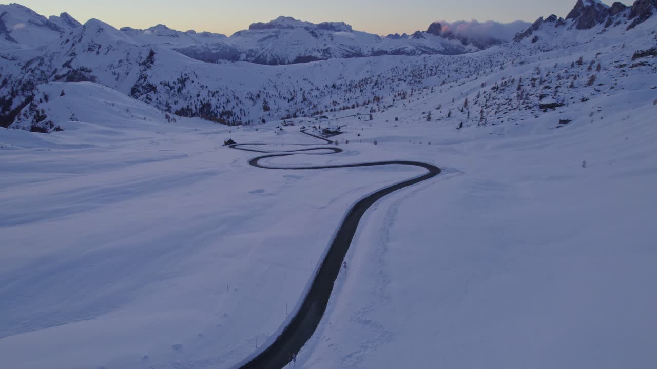 Winter sunset colors paint the Dolomites peaks, Passo di Giau, Italy