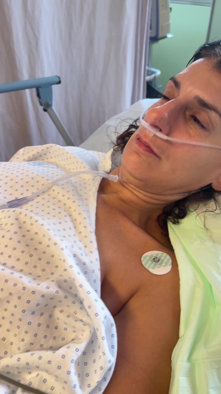 Paziente a riposo in un letto d'ospedale con apparecchiature di monitoraggio medico