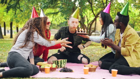 friends celebrating birthday picnic in park