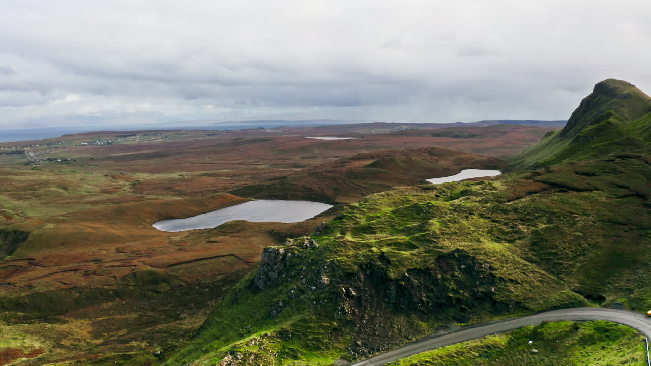 Rugged Green Cliffs, Lochs, And Moorland In Quiraing On Isle Of Skye, Scotland, UK. aerial shot