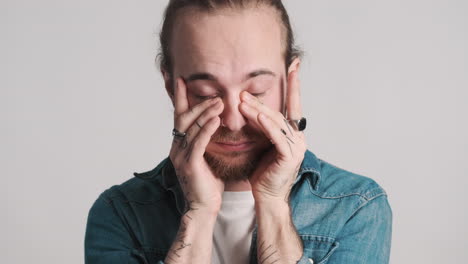 caucasian young man feeling tired on camera.