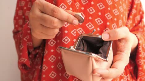 woman holding an empty coin purse