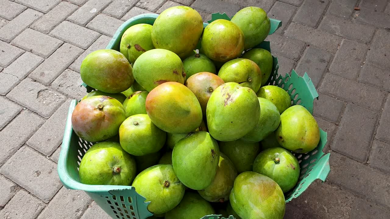deliciosos mangos verdes tropicales frescos en el mercado local de frutas y verduras en dili, timor leste, sudeste de asia