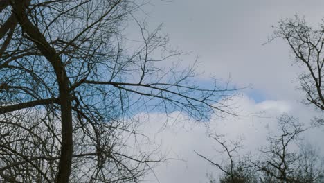 a helicopter passes by above at high altitude in a cloudy day