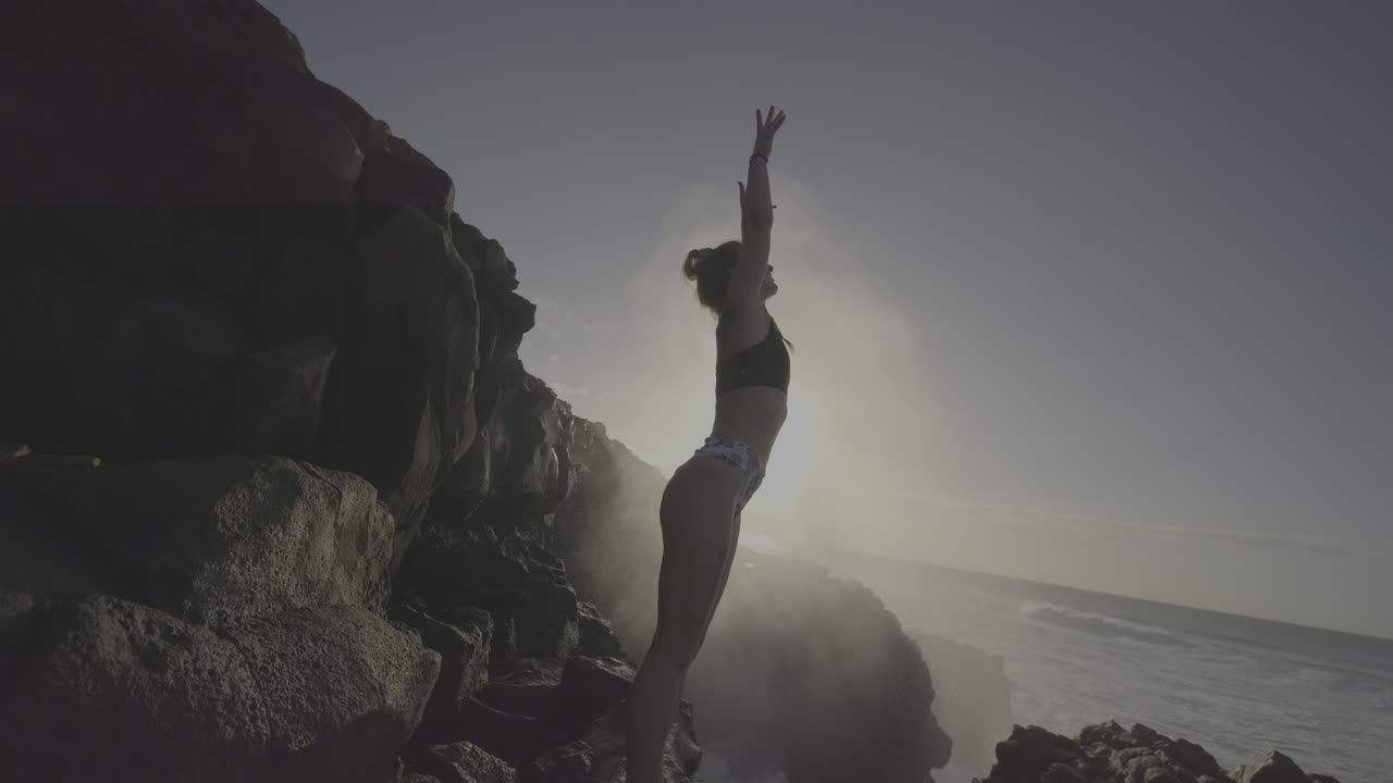 Woman on the rocks by the ocean