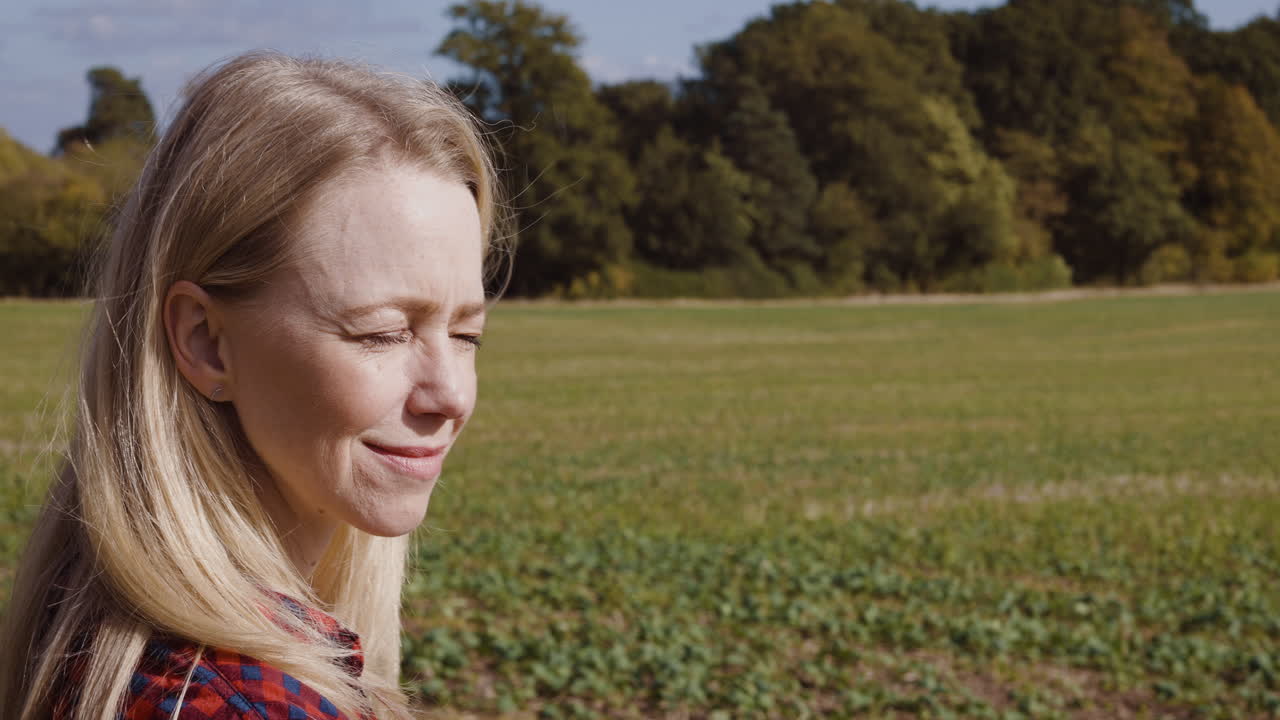 Green field with trees in the background