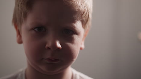 Chubby-little-boy-with-sweat-on-face-looks-in-camera