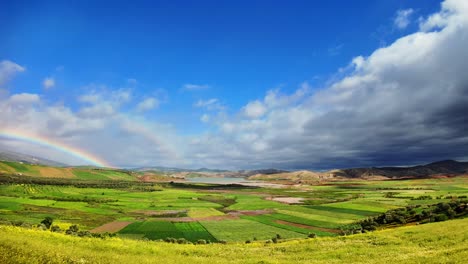 rainbow over countryside green field in north morocco agriculture land