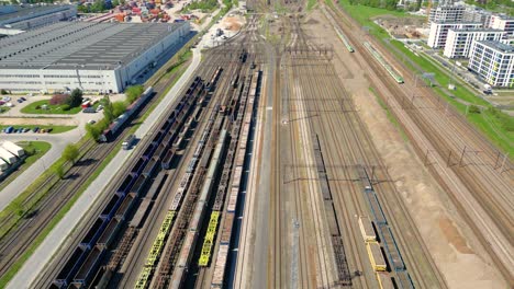 flying above industrial railroad station with cargo trains and freight containers