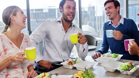 businesspeople interacting while having breakfast