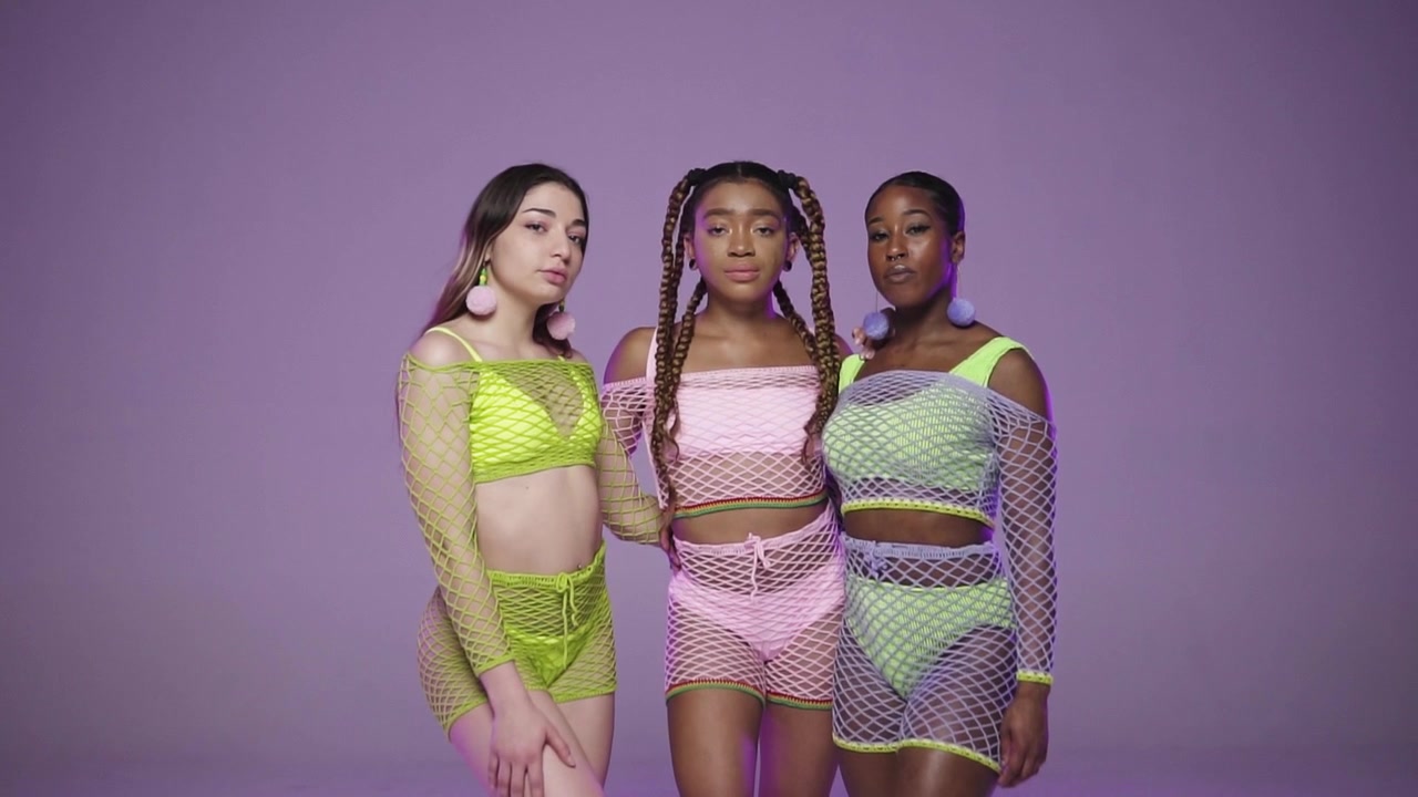 push in shot on three beautiful woman in colourful handmade outfits slow-mo