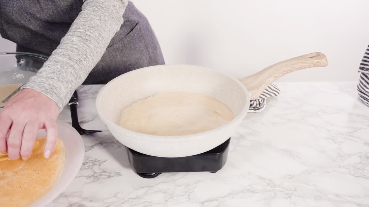 Making crepes in a small frying pan