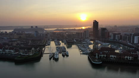 aerial flying toward boat harbour ocean village southampton during sunset 4k