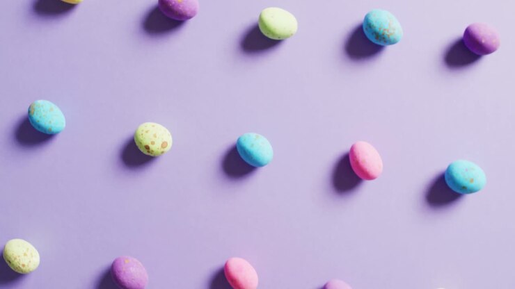Close up of multiple colorful easter eggs on purple background