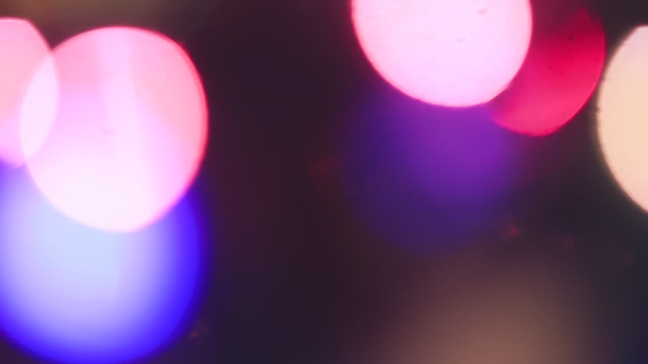 Blurred Christmas mystical multicolored lights flicker brightly.