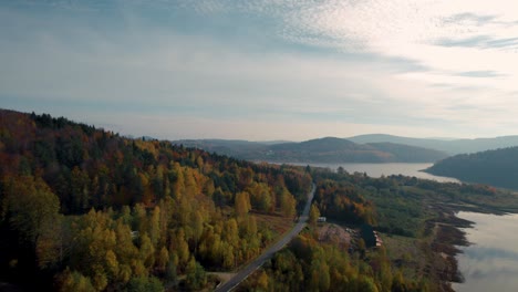 Aerial-Footage-of-Colorful-Forest-and-Lake-Surface-in-Autumn-Season