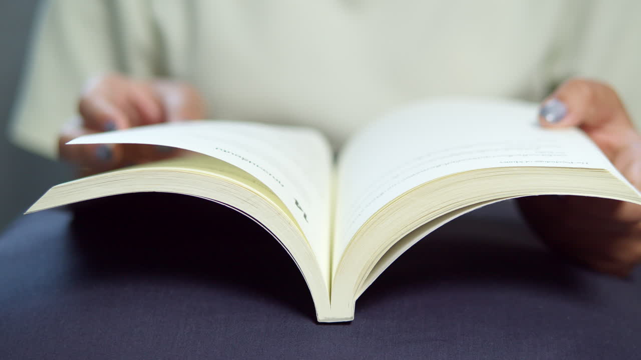 A person immersed in a book showcasing joy of reading in a cozy home setting