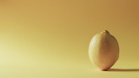 Video-of-lemon-with-copy-space-over-yellow-background