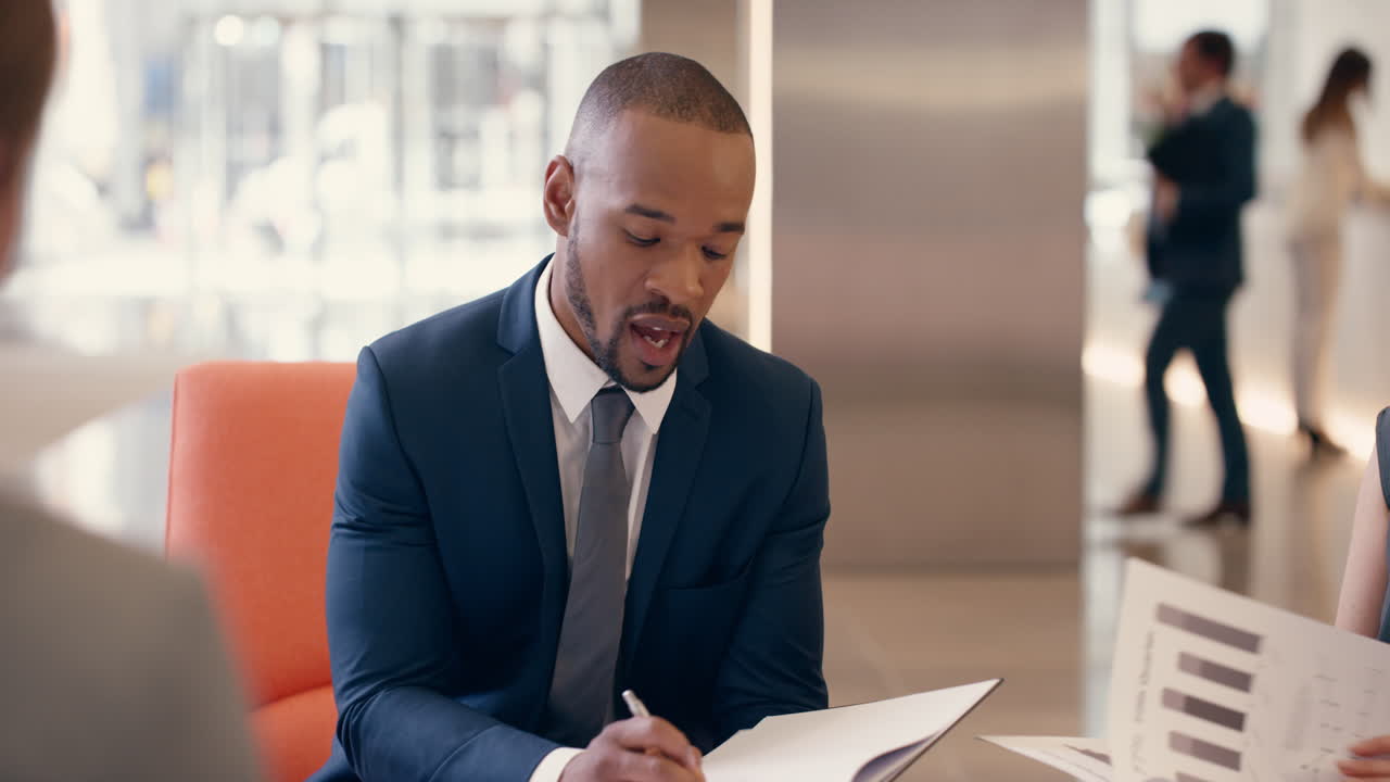Multi-Ethnic Business people working in business lobby